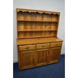 A MODERN PINE DRESSER, with three drawers, width 152cm x depth 52cm x height 184cm