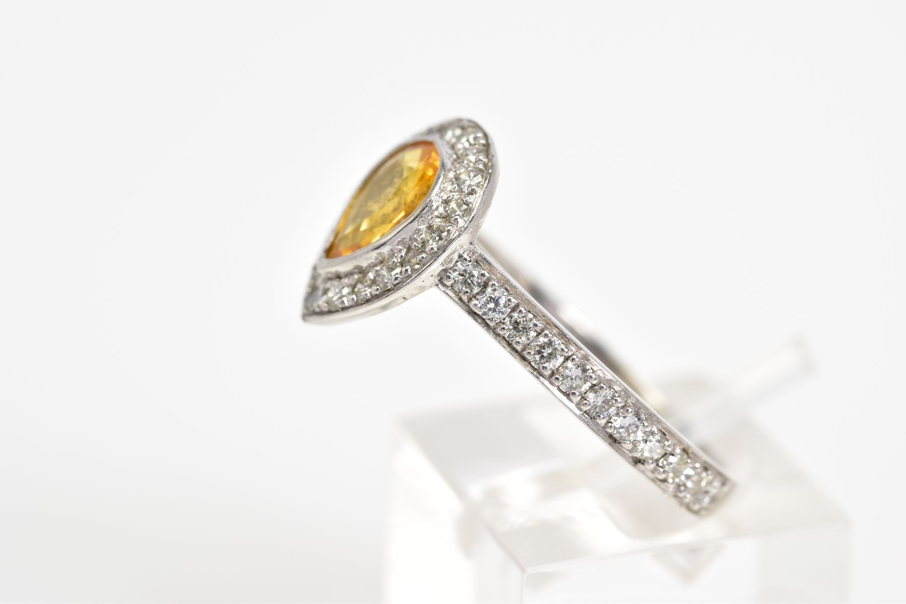 A YELLOW TOPAZ SET RING, the white metal ring set with a pear cut topaz with a round brilliant cut - Image 2 of 3