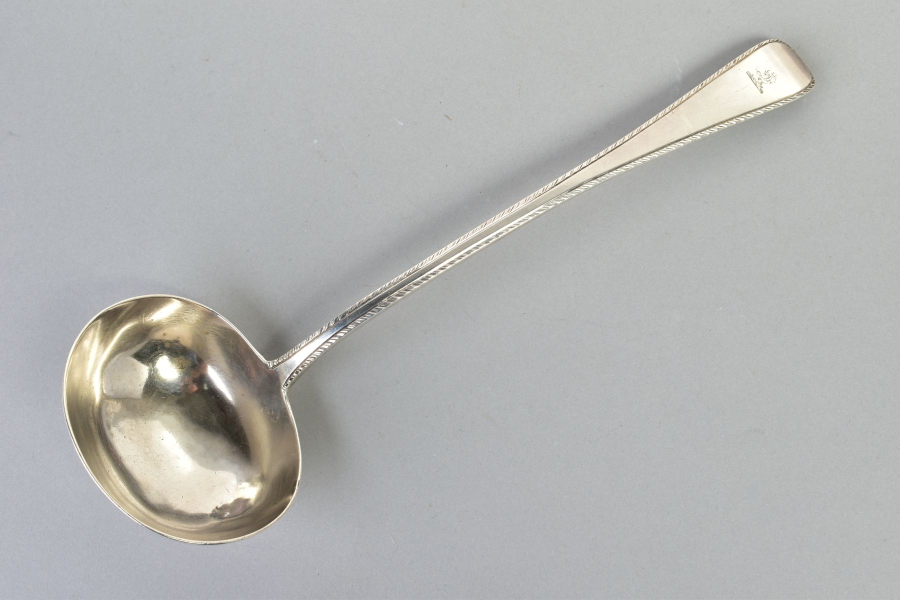 A VICTORIAN SILVER SOUP LADLE, of plain design with a feathered detail to the handle with an