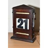 A WOODEN PERPETUAL DESK CALENDAR, having hand turn mechanism to alter the day, date and month,
