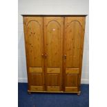 A MODERN PINE TRIPLE DOOR WARDROBE, width 137cm x depth 57cm x height 190cm