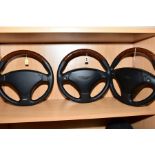 THREE MODERN ASTON MARTIN STEERING WHEELS, possibly for DB7 and Vantage models, leather and maple