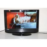A GOODMANS LD2357D 23'' TV (PAT pass and working) (one remote) and a black glass TV stand