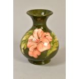 A BULBOUS MOORCROFT POTTERY VASE, in the 'Hibiscus' pattern impressed and painted backstamp, on