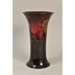 A MOORCROFT POTTERY FLAMBE TULIP VASE, leaf and berry pattern, signed to the base, dating from