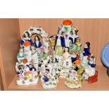 TEN VICTORIAN STAFFORDSHIRE POTTERY FLATBACKS, spill vases etc, including boy and girl on a sofa