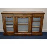 A 19TH CENTURY WALNUT BREAKFRONT TRIPLE DOOR CREDENZA, with foliate brass mounts, width 181cm x