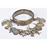 A CHARM BRACELET AND BANGLE, the charm bracelet with thirty four charms such as various animal