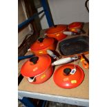 A SET OF FOUR GRADUATED LE CREUSET PANS AND COVERS (the smallest pan having chip to the cover and