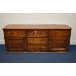 A GEORGE III OAK AND MAHOGANY CROSSBANDED DRESSER BASE, with five assorted drawers and double