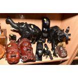 A COLLECTION OF AFRICAN AND ORIENTAL CARVINGS OF ANIMAL AND WALL MASKS, including elephants,