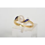 AN 18CT GOLD RING, designed with a central single cultured pearl, with blue enamel crossover