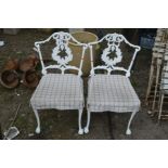 A PAIR OF WHITE PAINTED CAST ALUMINIUM GARDEN CHAIRS