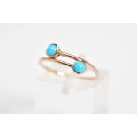 A TURQUOISE SET RING, of crossover design, set with two round cabochon turquoise, ring size L,