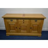 A SOLID LIGHT OAK SIDEBOARD, with four assorted drawers above three cupboard doors, width 170cm x