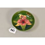 A SMALL MOORCROFT POTTERY FOOTED BOWL, orchid pattern on green ground, impressed backstamp,