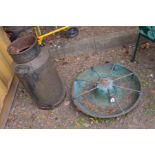 A CIRCULAR CAST IRON PIG FEEDER, approximate diameter 69cm together with a vintage milk churn (no