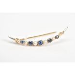 A CRESCENT BROOCH, set with circular cut sapphires, each within a four claw setting, interspaced