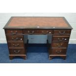 A REPRODUCTION MAHOGANY PEDESTAL DESK, leather style inlay and nine assorted drawers, width 122cm