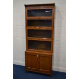 AN EARLY 20TH CENTURY GOLDEN OAK GUMM FIVE SECTIONAL BOOKCASE, the top four sections with glazed