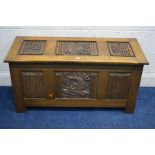 AN OAK BLANKET CHEST, with linenfold panels to all sides, carved dragons to the top and front,