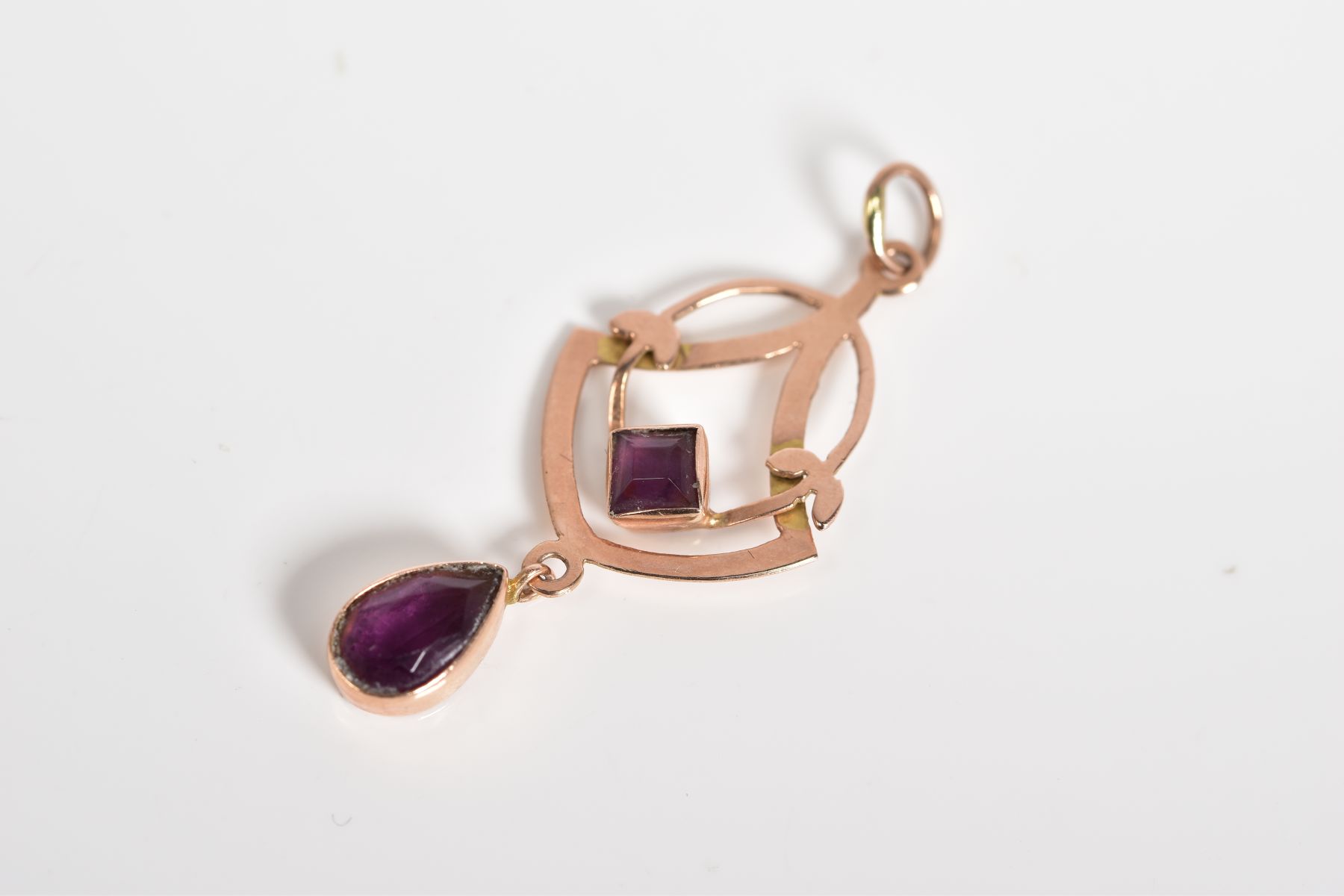 AN AMETHYST PENDANT, of openwork design set with a square cut amethyst suspending a further pear cut - Image 2 of 2