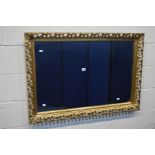 A FOLIATE GILT WOOD FRAMED WALL MIRROR 105cm x 74cm