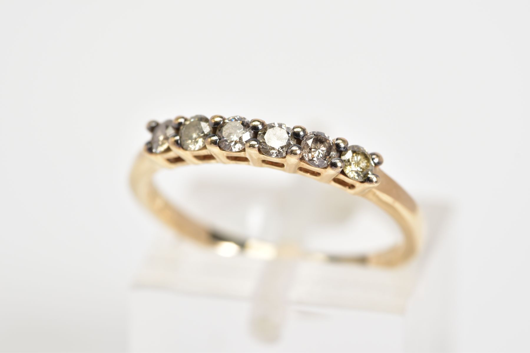 A 9CT GOLD DIAMOND HALF ETERNITY RING, set with six round brilliant cut diamonds, to the plain