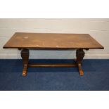 A REPRODUCTION OAK RECTANGULAR REFECTORY TABLE on twin square tapering supports united by a floor