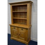 A SOLID LIGHT OAK BOOKCASE, the top with an open top with adjustable shelves, two drawers above