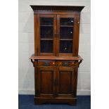 AN EARLY 20TH CENTURY MAHOGANY DOUBLE DOOR BOOKCASE, above two drawers and double panelled doors,