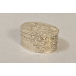 A LATE 19TH CENTURY OVAL SILVER BOX, repousse decorated with cherubs in landscapes, marked to base