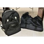 AN ASTON MARTIN RACING BRANDED HOLDALL/SOFT SUITCASE, has two wheels and collapsible handle,