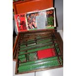 A QUANTITY OF MECCANO, mainly from the red and green era, to include flexible and flanged plates,