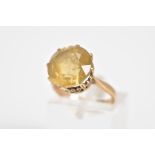 A CITRINE RING, set with a circular cut citrine within an eight claw setting, heart shape open