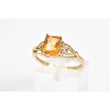A 9CT GOLD CITRINE RING, designed with a central rectangular cut citrine, within a four claw