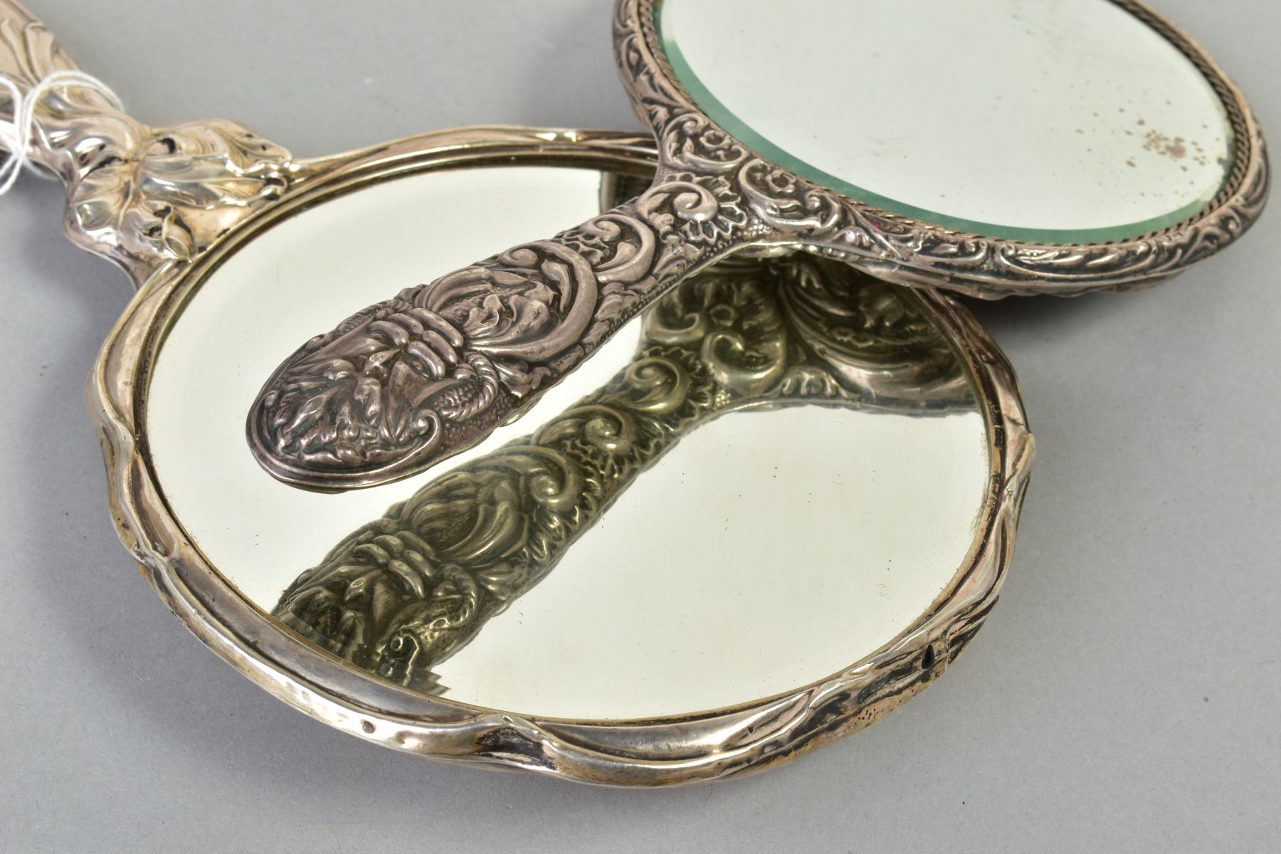 TWO SILVER MOUNTED HAND HELD MIRRORS, both with floral and foliate design, the first with an - Image 4 of 4