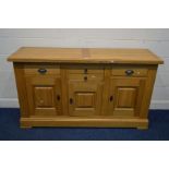 A SOLID LIGHT OAK SIDEBOARD, with four assorted drawers above three cupboard doors, width 170cm x