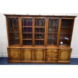 A BEVAN FUNNEL REPRODUX MAHOGANY FOUR SECTION WALL UNIT, four glazed doors, one with open