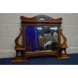 AN ARTS AND CRAFTS OAK BEVELLED EDGE OVERMANTEL MIRROR, with two shelves, width 97cm x height 81cm