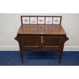 AN EARLY TO MID 20TH CENTURY OAK DOUBLE DOOR WASHSTAND with a later tile back and replacement top,