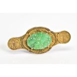 AN ORIENTAL STYLE BROOCH, set with an oval jadeite panel, embossed oriental design surround,