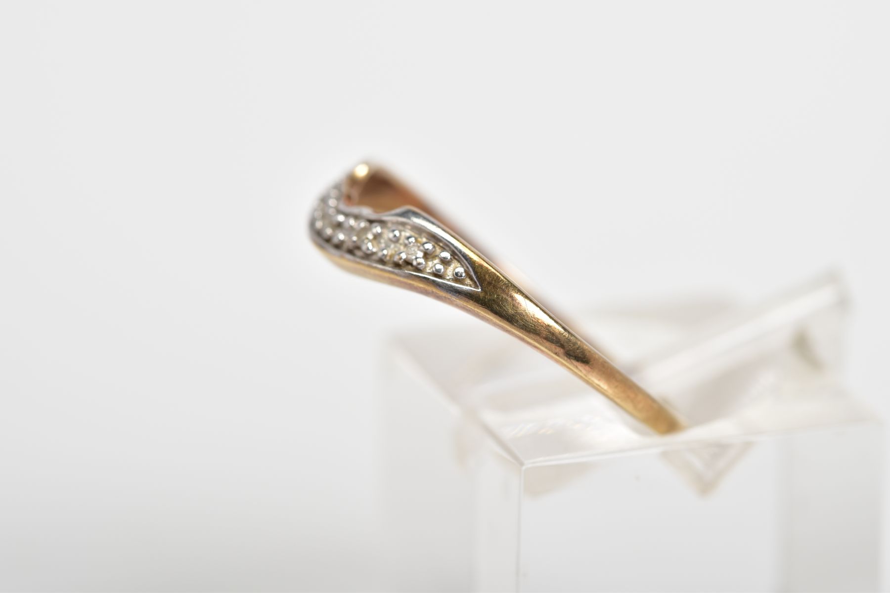 A 9CT GOLD DIAMOND RING, of V shape design, set with a row of single cut diamonds, to the plain - Image 2 of 3