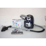 A BOSCH ALL FLOOR VACUUM CLEANER with spare nozzles and three new boxed filters (PAT pass and