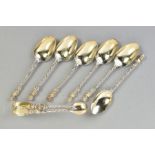 A SET OF SIX SILVER TEASPOONS AND A PAIR OF SUGAR TONGS, all with the detailed engraving of a cherub