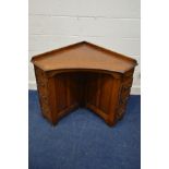 AN EARLY TO MID 20TH CENTURY OAK CORNER DESK with eight drawers, width 75cm x depth 75cm x height