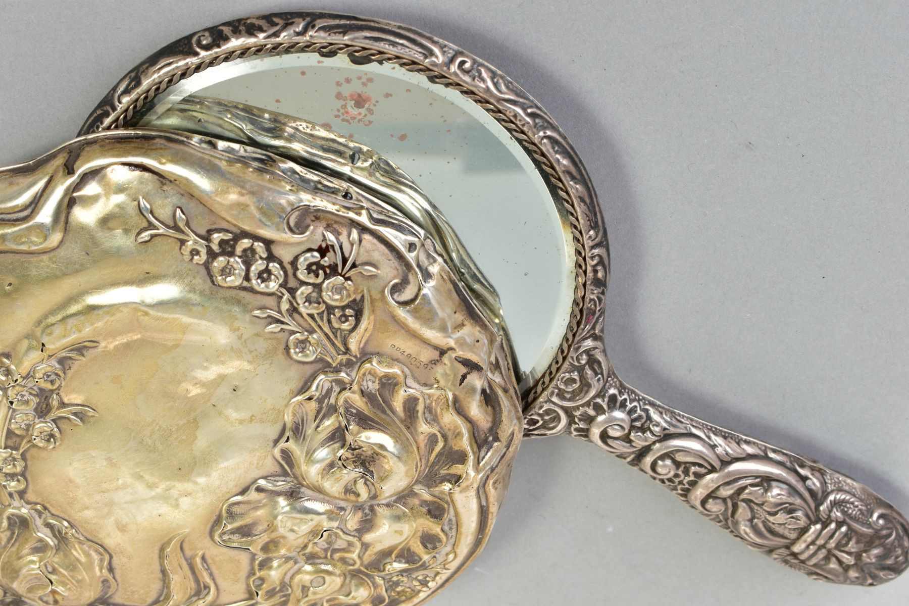 TWO SILVER MOUNTED HAND HELD MIRRORS, both with floral and foliate design, the first with an - Image 3 of 4