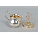 A SILVER CREAM JUG AND A SILVER RING TREE, the jug of plain design approximately 70mm tall,