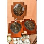 THREE WOODEN PLAQUES in the form of a cross mounted with metal images of Christ's face, each