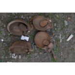 A SET OF FOUR CAST IRON CATTLE WATER BOWLS